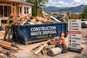 Construction waste disposal in Asheville NC with roll-off dumpster on renovation job site showing wood, drywall, and demolition debris